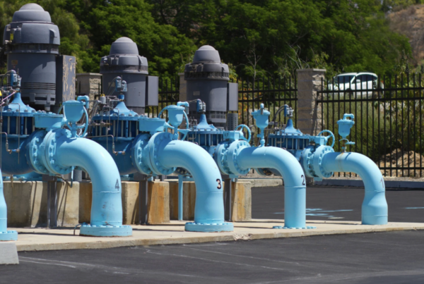 municipal water pumping station featuring multiple industrial vertical turbine pumps and blue-painted